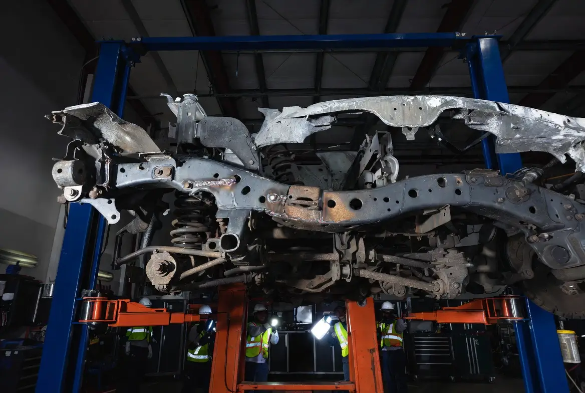 Bent truck chassis frame showing visible deformation and alignment issues